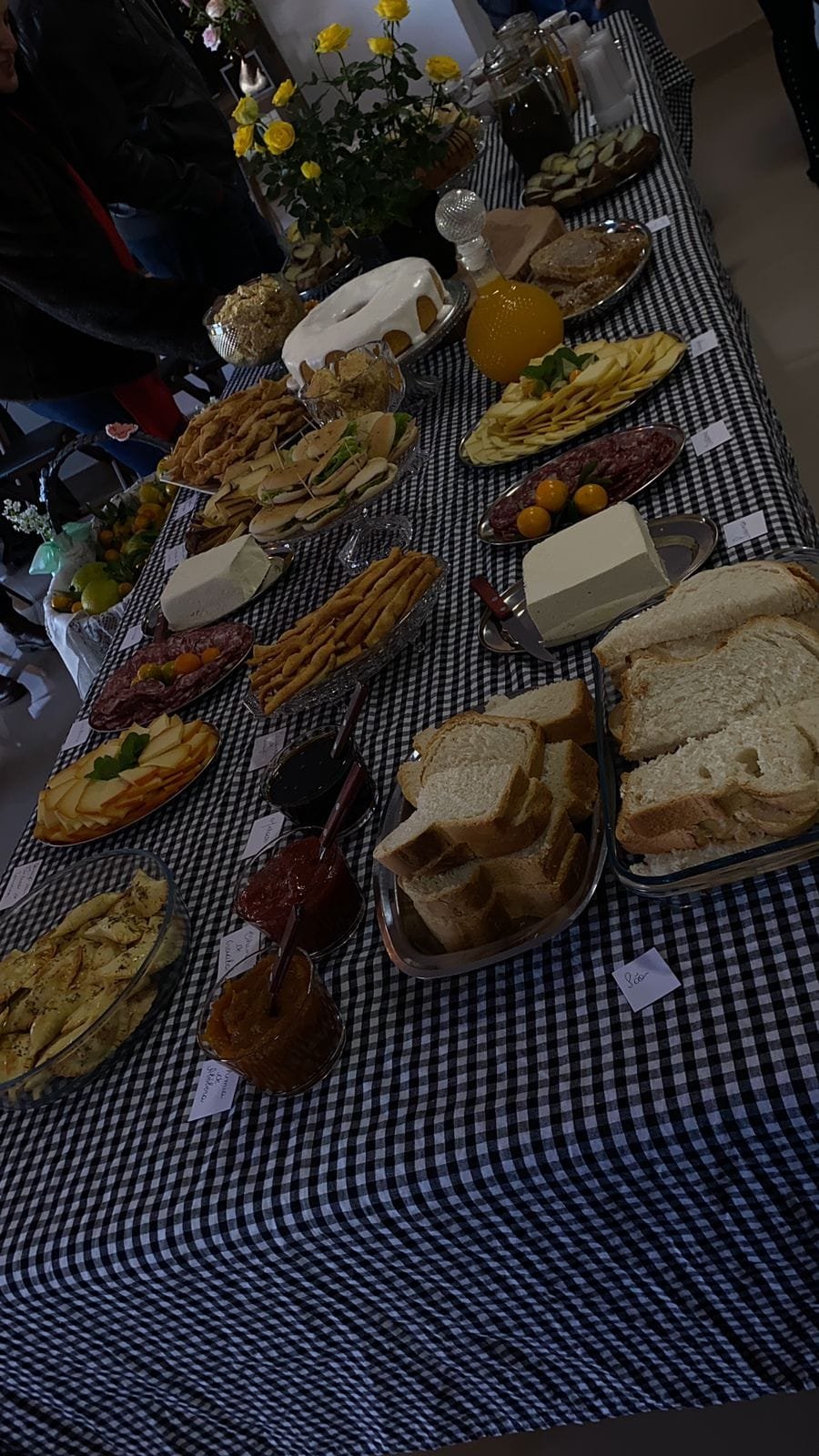Tortas, pães e cucas servidos sobre a toalha xadrez